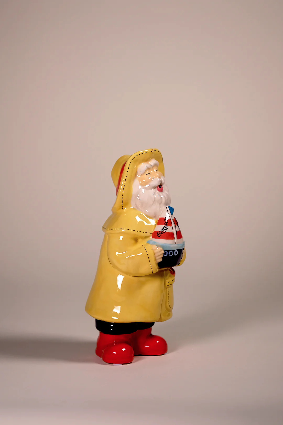 Man Holds the Sailboat Figurine - Image 5